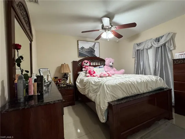 Bedroom featuring light tile patterned floors and a ceiling fan