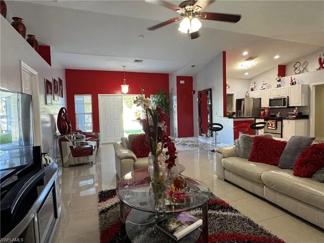 Living room featuring recessed lighting, visible vents, light tile patterned flooring, and a ceiling fan