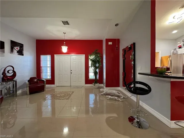 Entrance foyer with visible vents and baseboards
