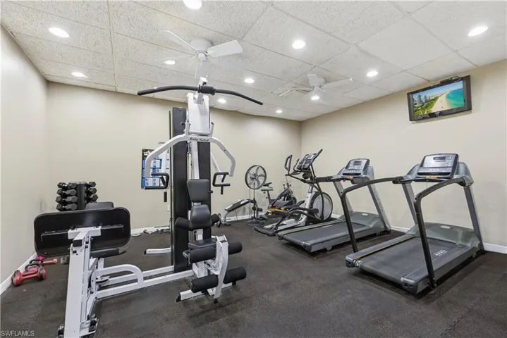 Dedicated fitness space featuring rubber flooring, recessed lighting, and dual ceiling fans
