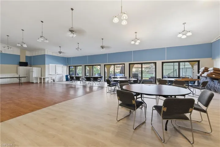Spacious multi-purpose room featuring a combination of wood-finish flooring and lighter-toned wood-finish flooring