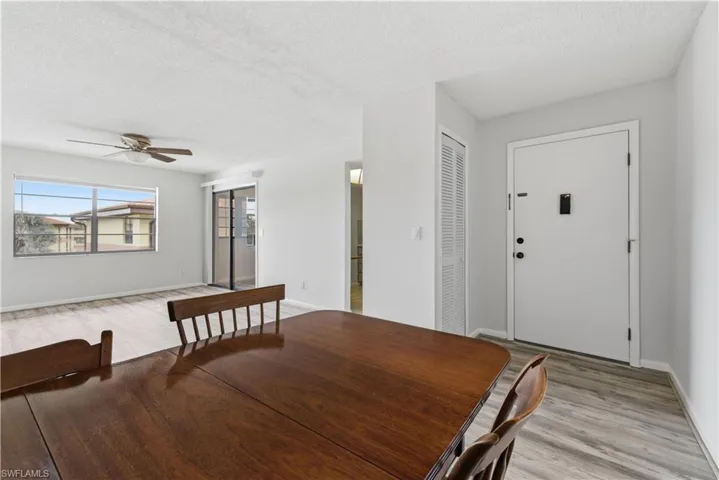 Open concept interior featuring light gray wall paint and wood-finish flooring