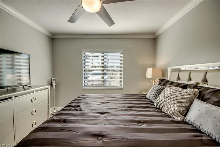 Bedroom with crown molding and ceiling fan