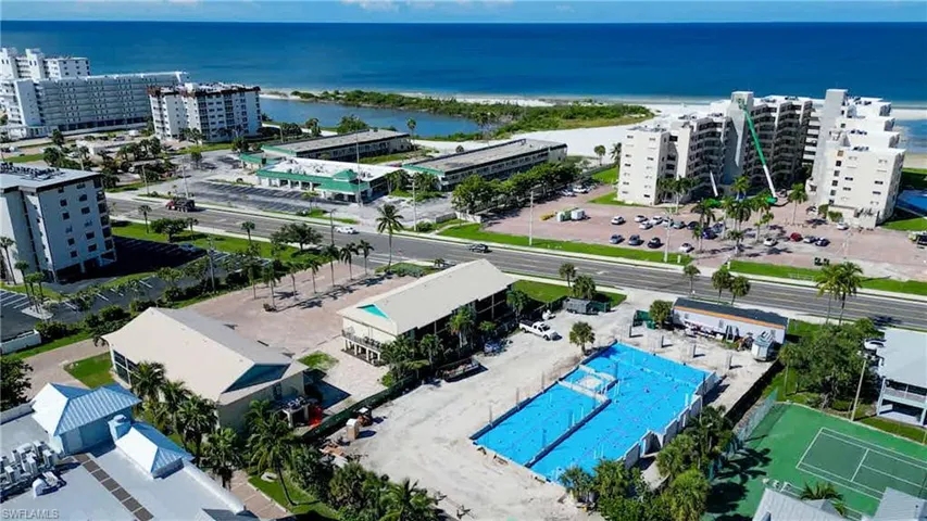 View of urban area featuring a nearby body of water and a pool