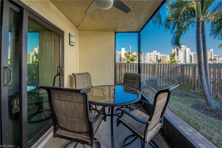 Balcony with a ceiling fan and outdoor dining space