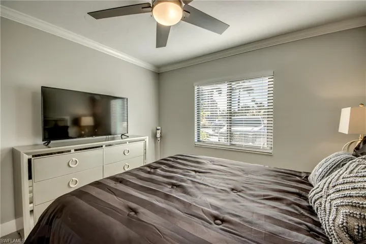 Bedroom featuring ornamental molding and ceiling fan