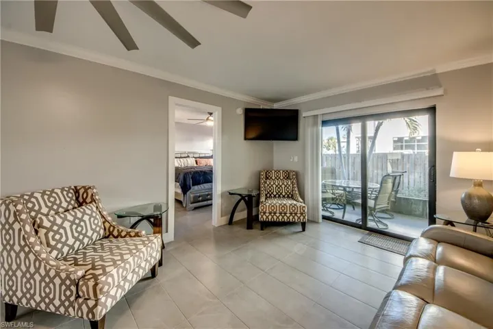Sitting room with crown molding and tile patterned flooring