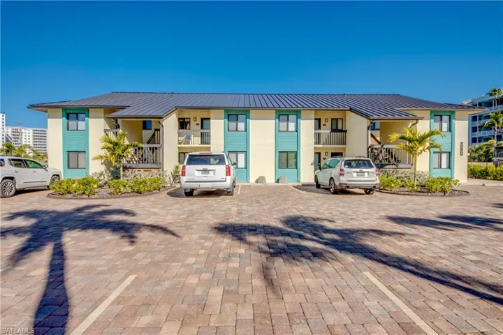 View of property featuring uncovered parking