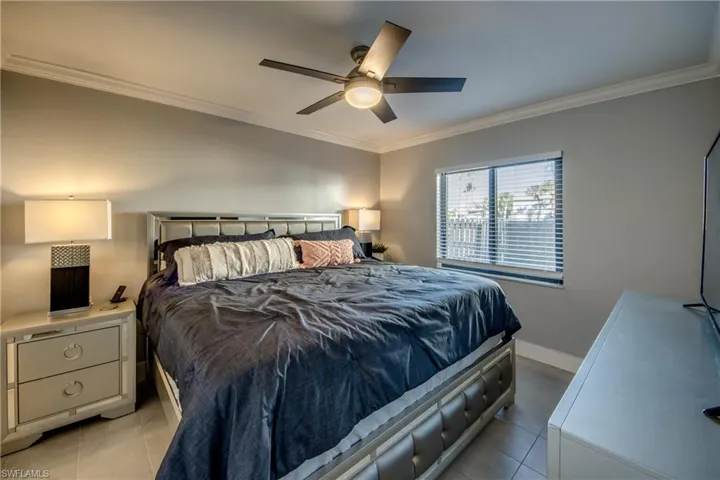 Bedroom featuring crown molding and a ceiling fan