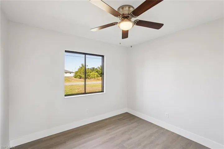 Spare room featuring wood finished floors and ceiling fan