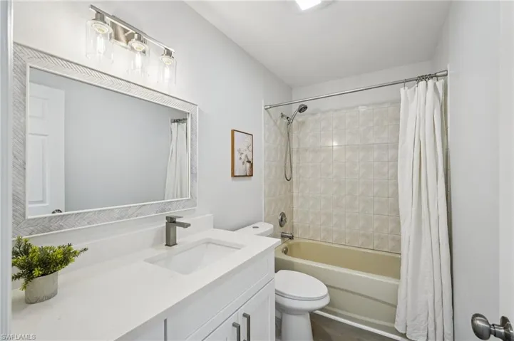 Full bathroom with shower / tub combo and vanity