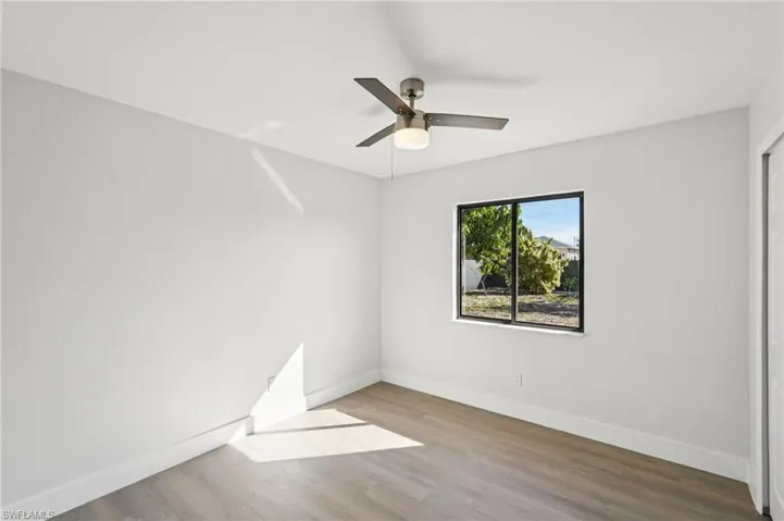 Empty room featuring wood finished floors and ceiling fan