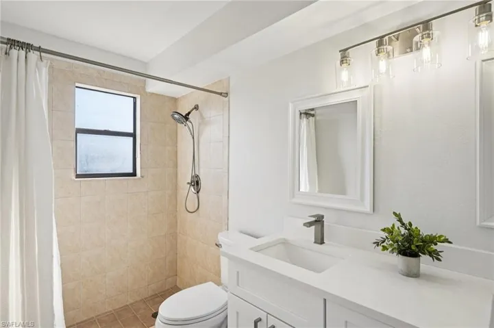 Full bathroom with vanity and a tile shower