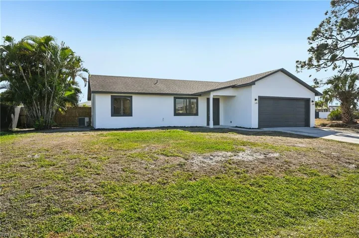 Ranch-style home featuring stucco siding, concrete driveway, a garage, and roof with shingles