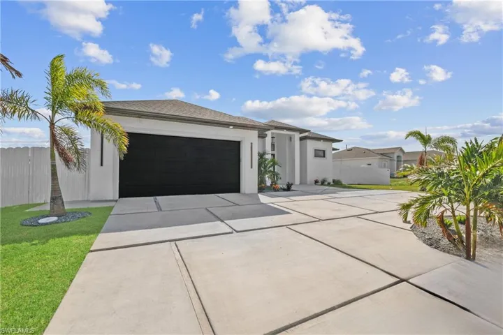 View of front of home with a garage and a front yard