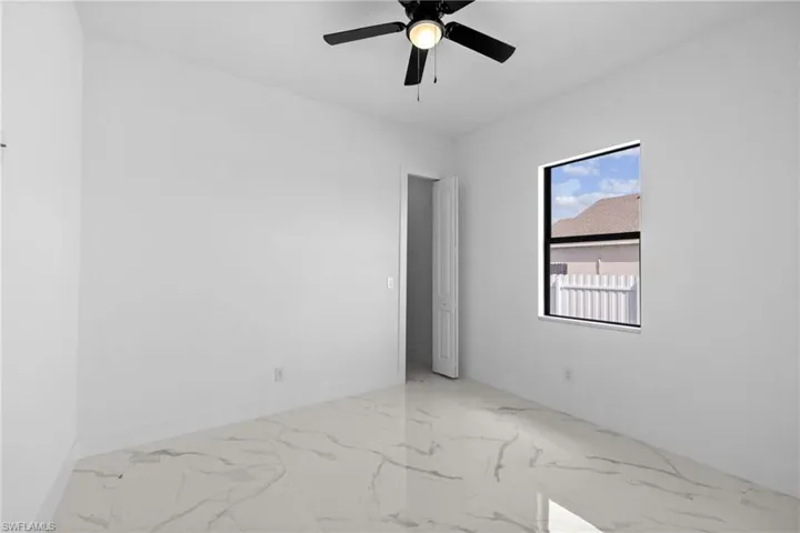Spare room with ceiling fan