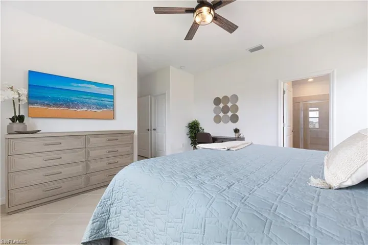 Bedroom with ceiling fan and ensuite bath