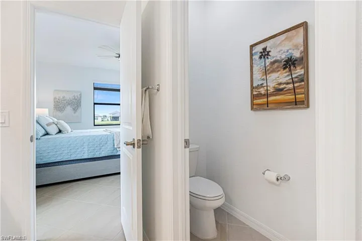 Ensuite bathroom with light tile patterned floors and baseboards