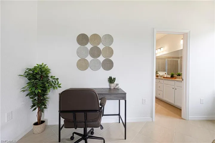 Office area with baseboards and light tile patterned floors