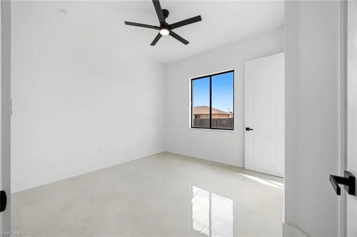 Unfurnished room featuring ceiling fan
