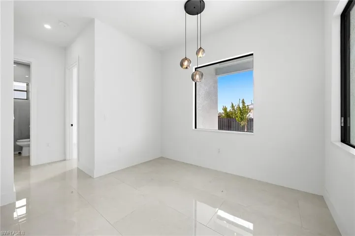 Unfurnished dining area featuring healthy amount of natural light, light tile patterned floors, and recessed lighting