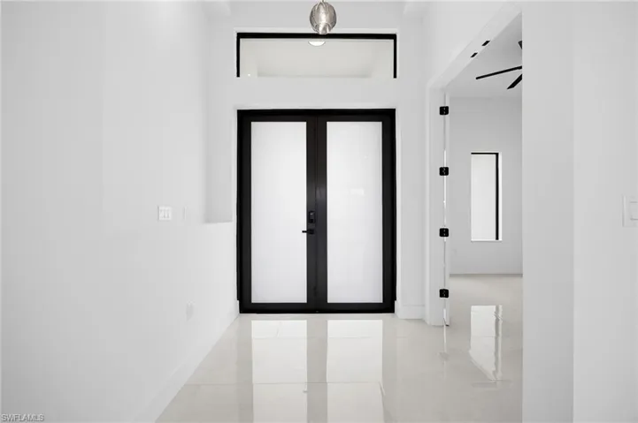 Foyer entrance with french doors and light tile patterned floors