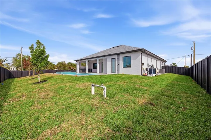 Rear view of house featuring a fenced backyard, a patio area, and stucco siding