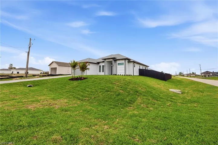 View of front facade featuring stucco siding and driveway