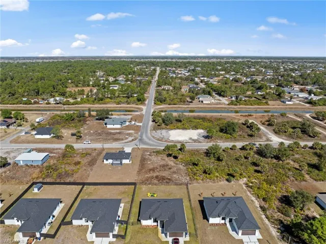 Aerial view of property's location with nearby suburban area