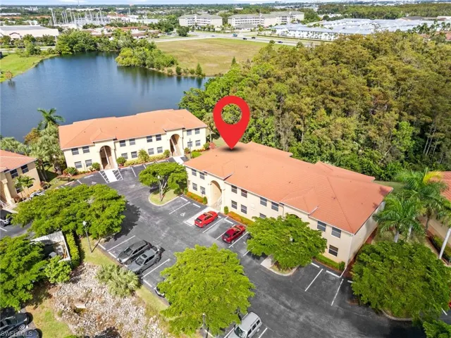 Birds eye view of property with a water view