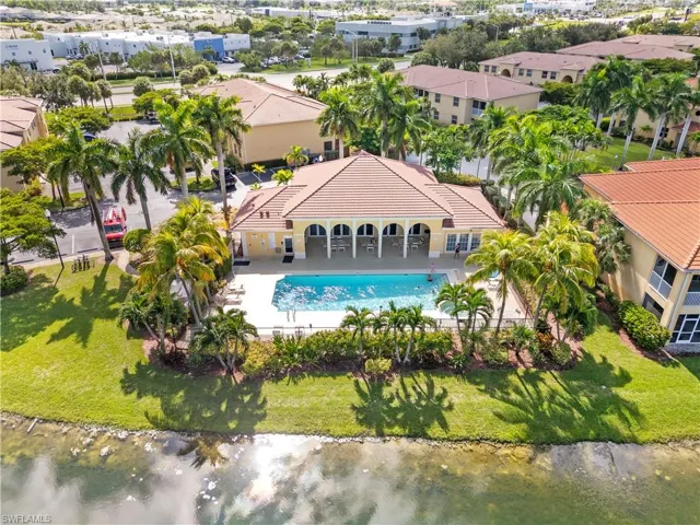 Birds eye view of property with a water view
