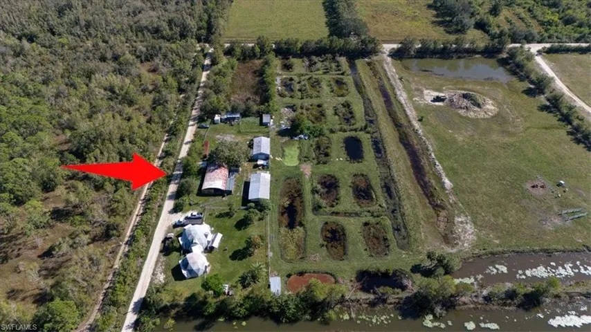 Aerial view of property's location featuring a nearby body of water and rural landscape