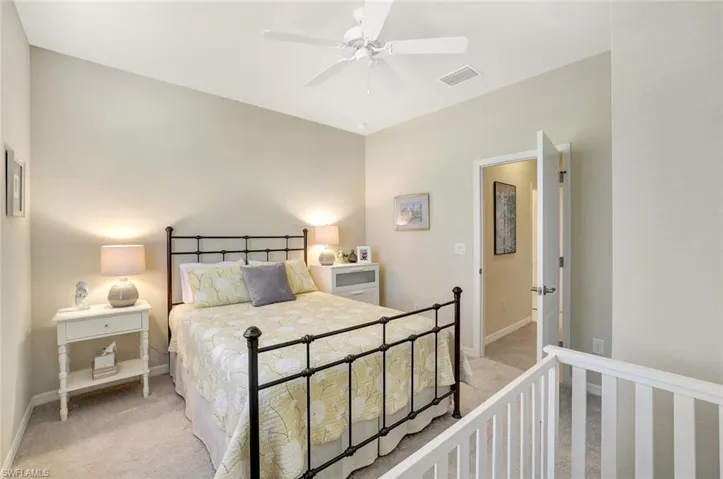 Carpeted bedroom featuring ceiling fan