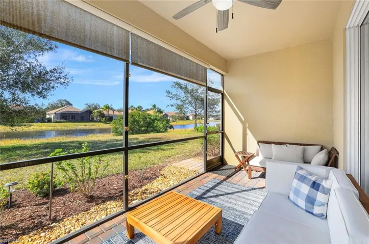 Sunroom / solarium with a water view and ceiling fan