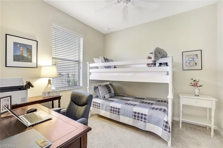 Carpeted bedroom with ceiling fan