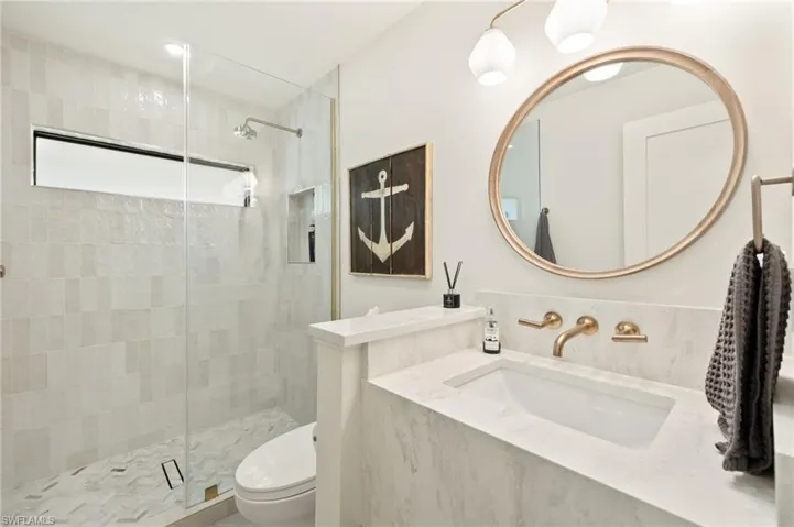 Bathroom featuring a stall shower and vanity
