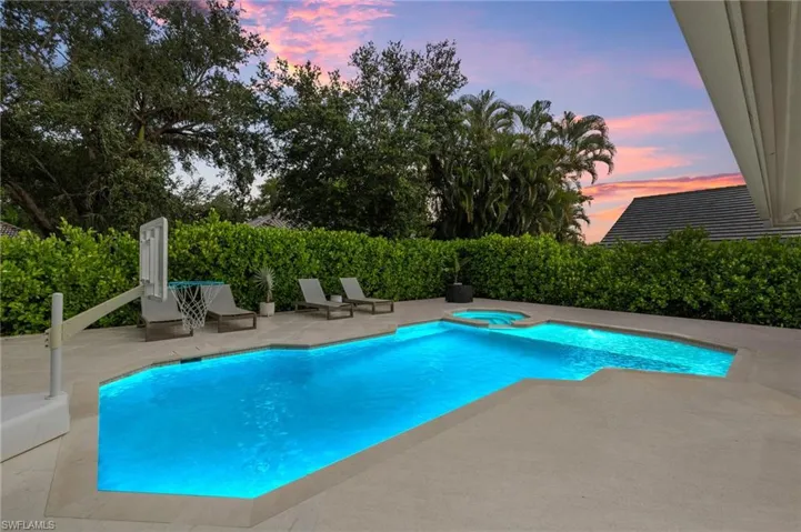 View of pool featuring a patio area and a pool with connected hot tub