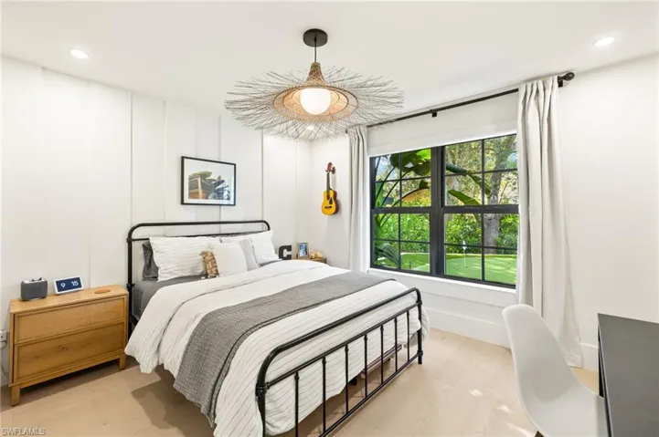Bedroom with light wood finished floors and recessed lighting