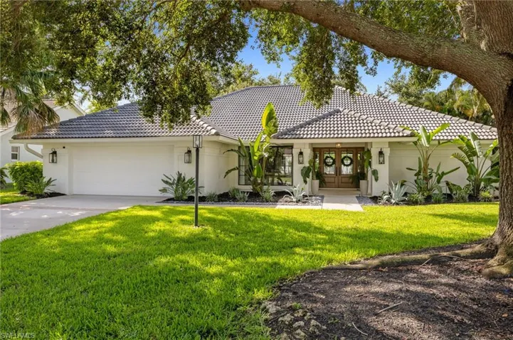 View of front of house featuring french doors, a tile roof, an attached garage, and stucco siding