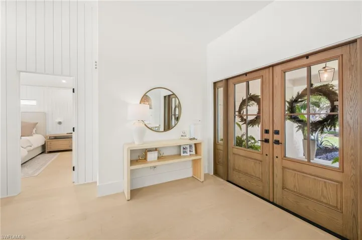 Entryway with wood finished floors and french doors