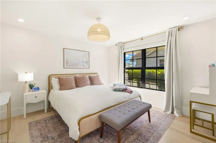 Bedroom with light wood finished floors and recessed lighting