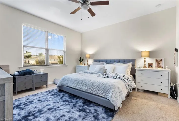 Carpeted bedroom with ceiling fan