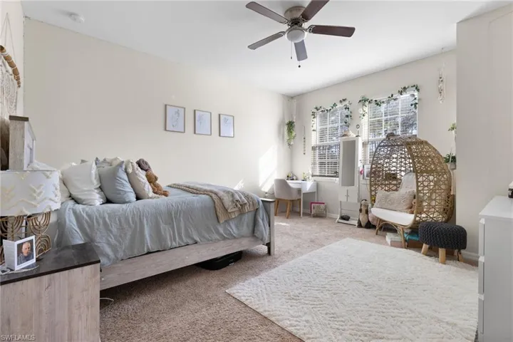Carpeted bedroom with ceiling fan