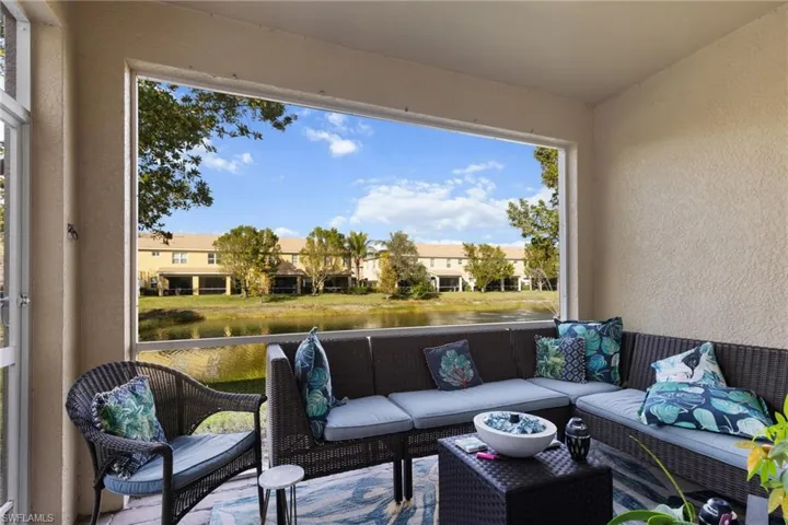 Sunroom / solarium featuring a water view