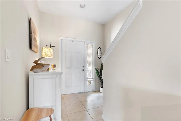 Foyer entrance with light tile patterned floors