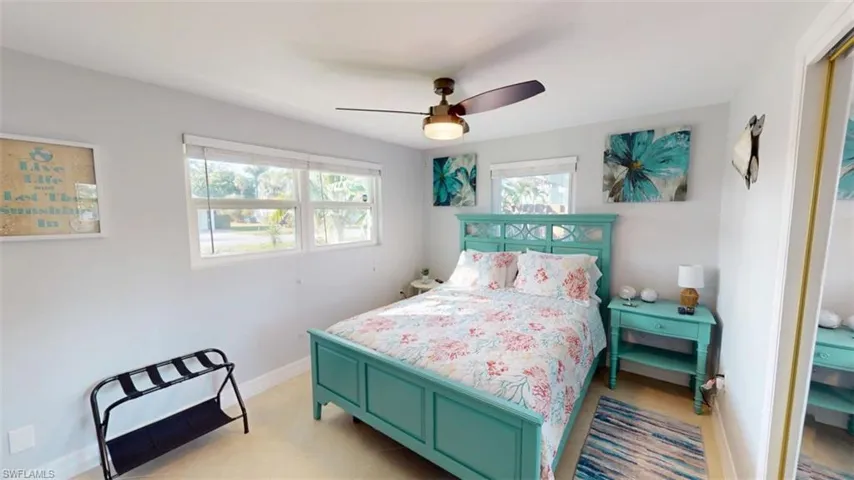 Bedroom featuring ceiling fan and baseboards