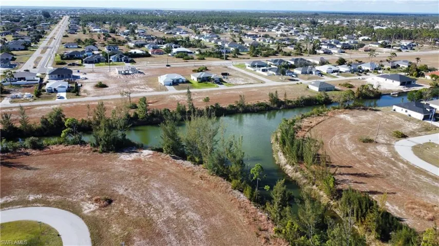 Birds eye view of property with a water view