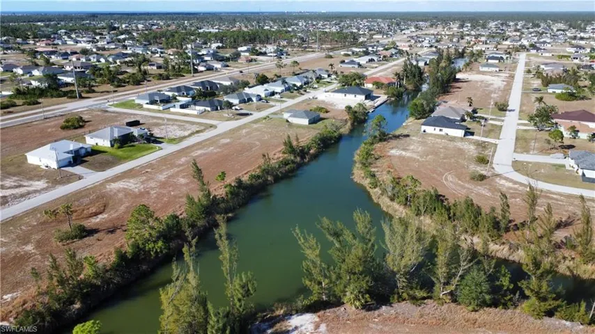 Birds eye view of property with a water view