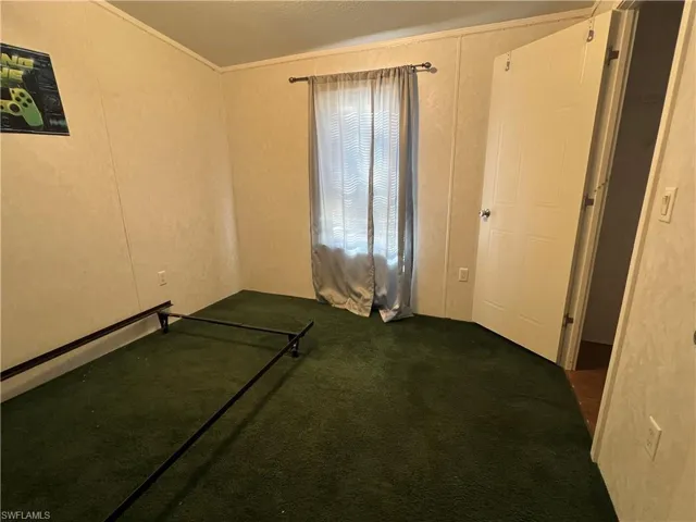 Unfurnished bedroom with ornamental molding
