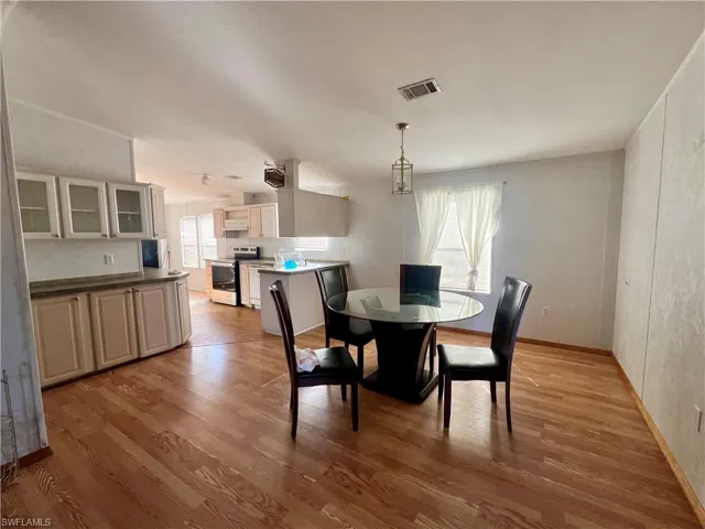 Dining space with light wood finished floors and baseboards